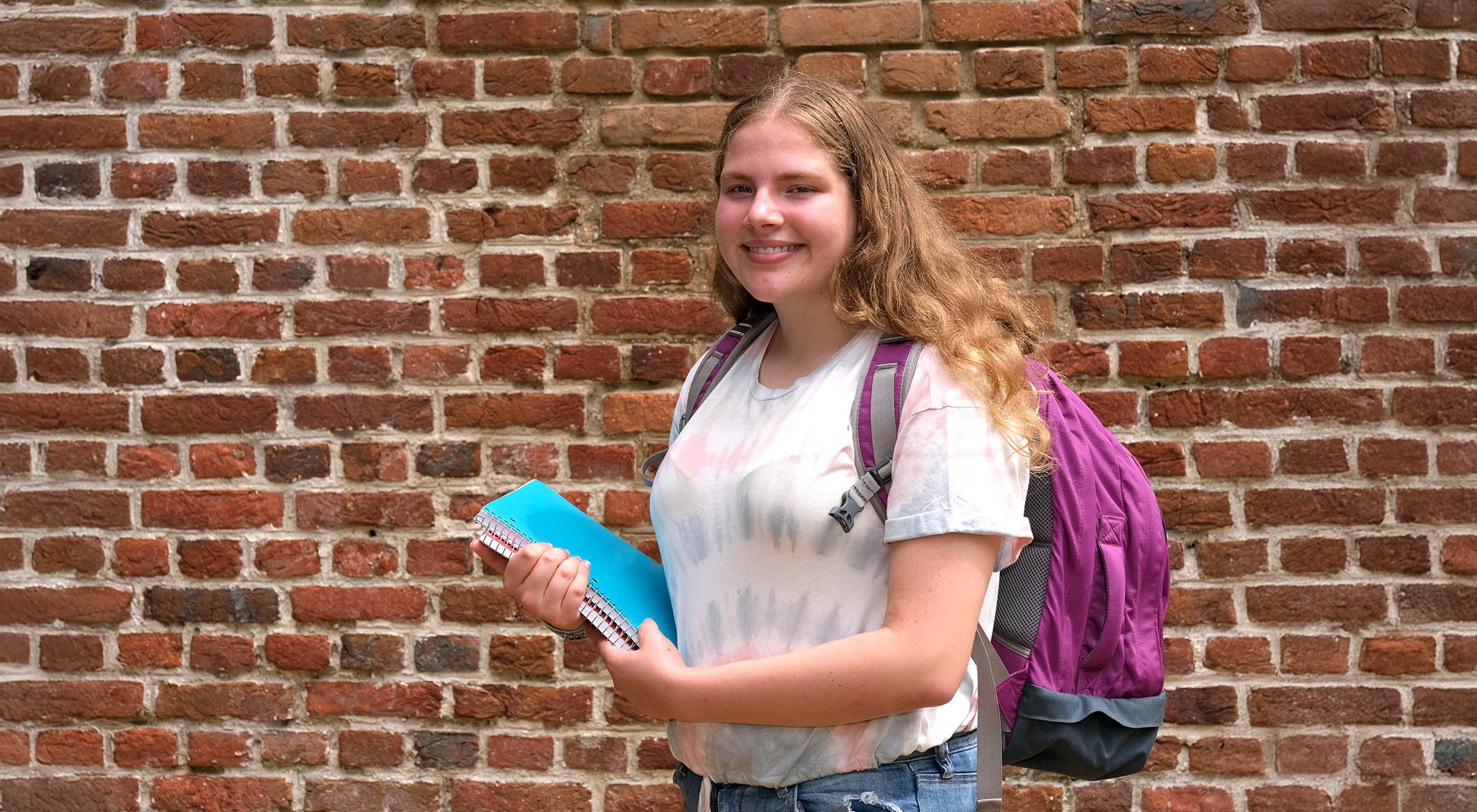 Girl with school books and backpack